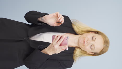 Vertical-video-of-Business-woman-dancing-with-phone-in-hand.